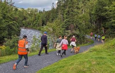 Community trail runners navigating the scenic trail loop by the river in Corner Brook.